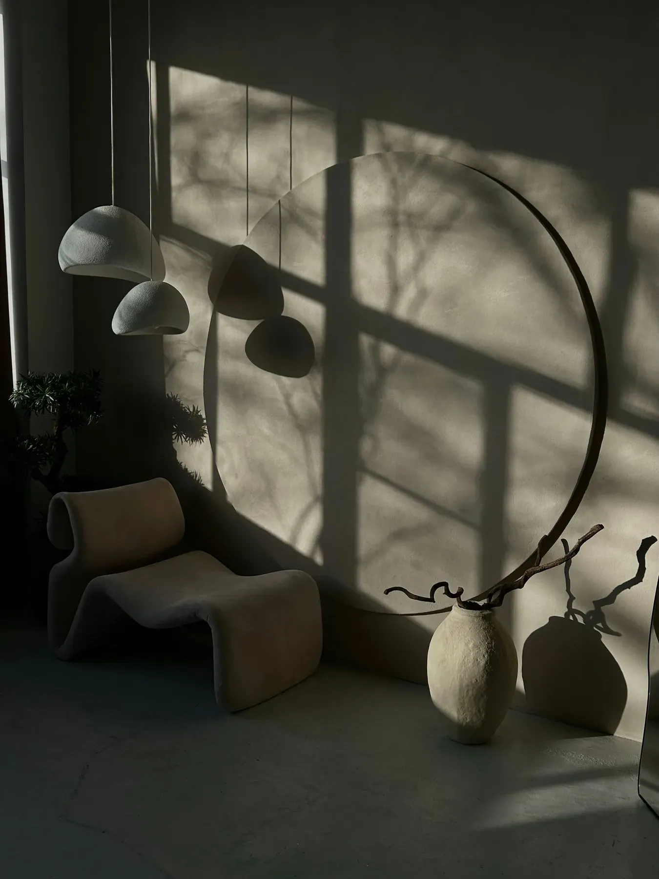 Sculptural lounge chair in a shadowed, atmospheric interior